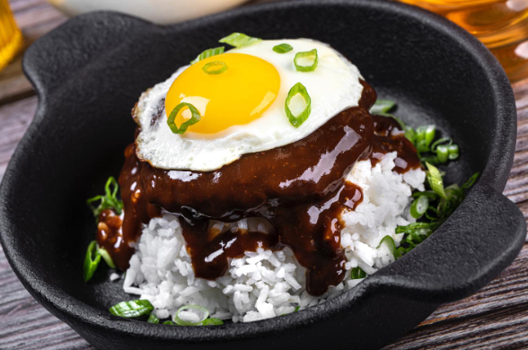 Loco Moco breakfast served at Early Birds in Las Vegas with rice, beef patty, gravy, and fried egg topped with green onions